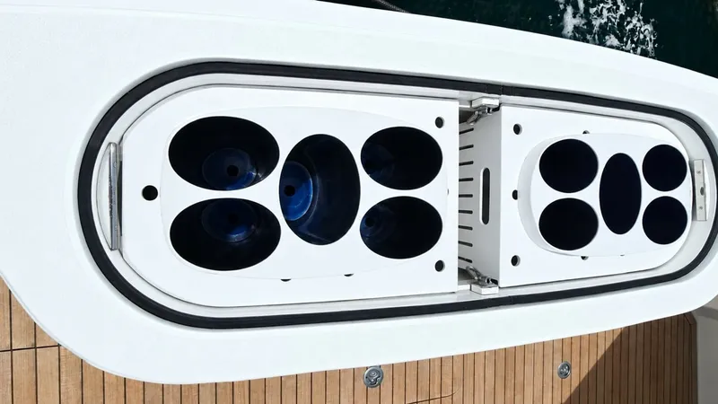 Slide: The Image of Integrated Deck Fish Storage The Viking 46 BF features a sophisticated integrated fish storage system on the deck. This compartment is designed with white fiberglass and equipped with multiple circular slots, ideal for storing bait or catches. The sleek design complements the teak de - 7854764