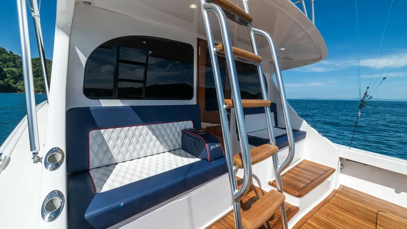 Slide: The Image of Cockpit Seating and Ladder Access This image showcases the cockpit of the Viking 46 BF, featuring comfortable seating with elegant diamond-stitched upholstery. The well-placed ladder provides easy access to the flybridge, seamlessly integrating functionality with style. The teak flooring - 7854766
