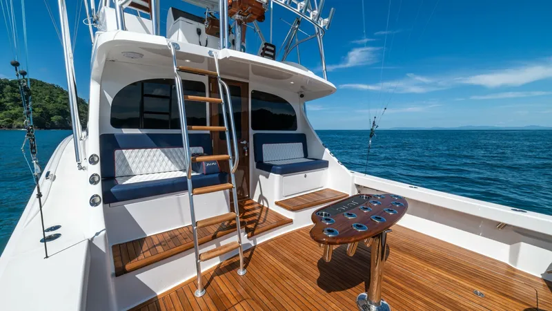 Slide: The Image of Spacious Teak Cockpit with Ladder The cockpit of the 2020 Viking 46 BF boasts elegant teak decking, providing both durability and a classic aesthetic. Equipped with a ladder leading to the flybridge, this area offers ample seating with plush cushions, perfect for relaxation or entertainin - 7854742