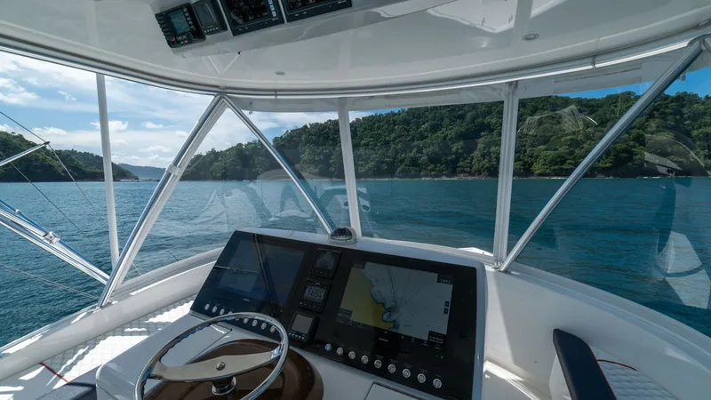 Slide: The Image of Flybridge Helm Station with Electronics The helm station on the Viking 46 BF offers a commanding view, equipped with advanced navigation electronics and a sleek, modern design. The ergonomic layout ensures easy access to controls, with a state-of-the-art display for seamless navigation. Surroun - 7854768