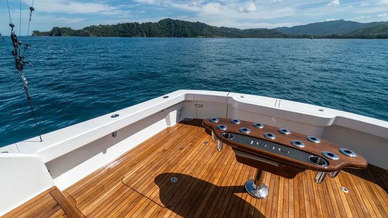 Slide: The Image of Spacious Teak Cockpit with Rod Holders The cockpit of the Viking 46 BF, vessel JUJU, showcases elegant teak decking, providing a durable and stylish surface for anglers and guests. Central to the space is a well-equipped fighting chair with multiple rod holders, ideal for serious fishing exped - 7854762