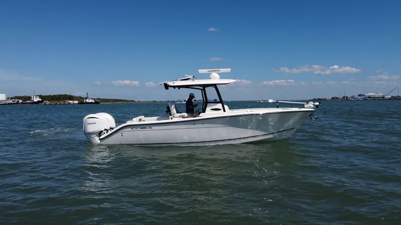 The Image of Side Profile on Open Water The 2023 Cobia 280 Center Console is showcased gliding effortlessly across open water. Its sleek, modern design is complemented by a robust Yamaha outboard engine, ensuring powerful performance. The T-top provides shade and houses advanced navigation equi - 7927747