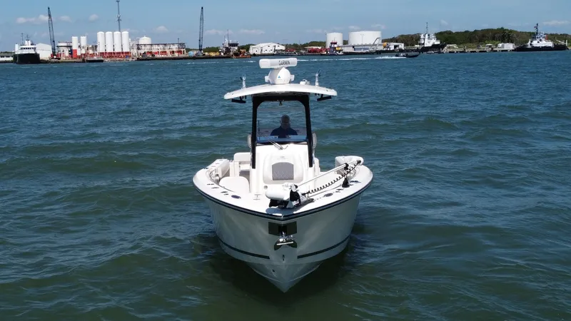 Slide: The Image of Bow View of Cobia 280 Center Console The 2023 Cobia 280 Center Console is showcased in a striking bow view, highlighting its sleek, V-shaped hull designed for optimal performance and stability on the water. The spacious forward deck offers ample room for fishing or relaxation, complemented b - 7927766