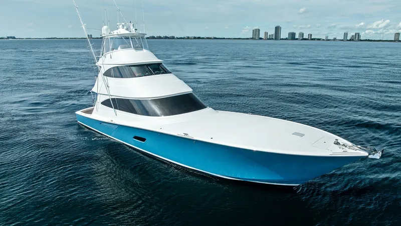 Slide: The Image of Aerial View of Forward Deck The Viking 80 Convertible 'Aussie Rules' showcases a sleek and powerful design from an aerial perspective. Its striking blue hull contrasts beautifully with the crisp white superstructure, highlighting the vessel's elegant lines. The expansive forward dec - 7932716