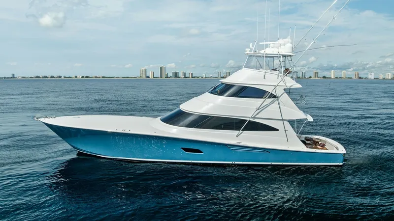 Slide: The Image of Side View of Sportfishing Yacht This image showcases the sleek side profile of the 2017 Viking 80 Convertible, 'Aussie Rules'. The vessel features a striking blue hull and aerodynamic lines, emphasizing its sporty design and high-performance capabilities. The spacious flybridge and eleg - 7932719