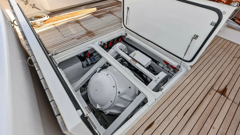 Slide: The Image of Engine Room Hatch Access This image showcases the engine room hatch on the Viking 80 Convertible 'Aussie Rules'. The neatly organized compartment features a state-of-the-art engine system, highlighted by its clean and efficient layout. The teak decking adds a touch of luxury, ens - 7932699
