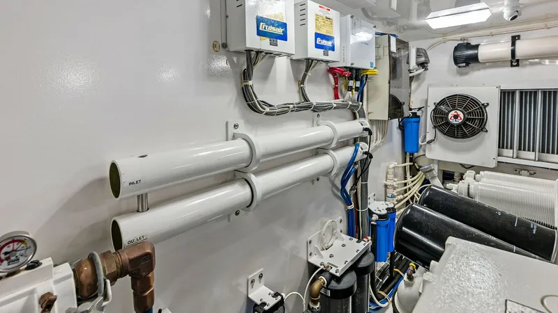 Slide: The Image of Engine Room with Advanced Systems The engine room of the 2017 Viking 80 Convertible 'Aussie Rules' showcases a meticulously organized space, equipped with state-of-the-art mechanical systems. Visible are robust filtration units and electrical panels, ensuring optimal performance and relia - 7932708