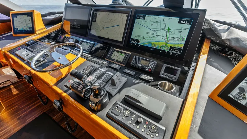 Slide: The Image of Helm Station with Navigation Displays The helm station of the 2017 Viking 80 Convertible 'Aussie Rules' features an advanced navigation suite with multiple high-resolution displays. The sleek, ergonomic design includes a polished steering wheel and intuitive control panels, ensuring precise m - 7932682