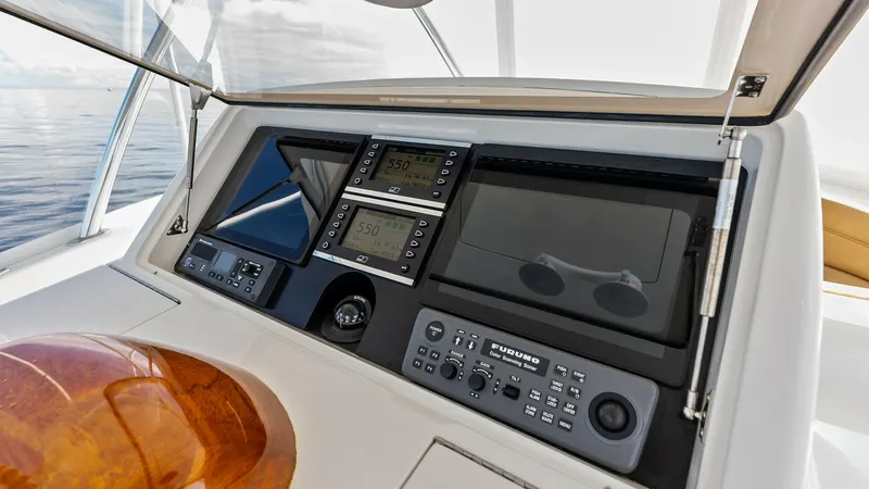Slide: The Image of Flybridge Helm Station Electronics Display The helm station on the Viking 80 Convertible features a sophisticated electronics display, ensuring precise navigation and control. Multiple digital screens provide comprehensive data and easy access to essential functions, all protected by a sleek, tran - 7932689