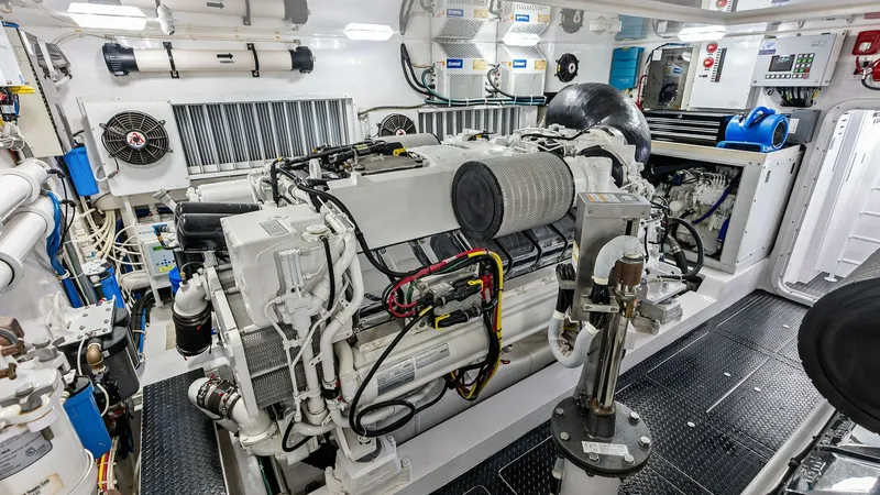 Slide: The Image of Engine Room with Twin Engines The engine room of the 2017 Viking 80 Convertible 'Aussie Rules' showcases twin engines meticulously arranged for optimal performance. The space is well-organized, featuring advanced systems and equipment ensuring reliability and efficiency. Bright lighti - 7932710