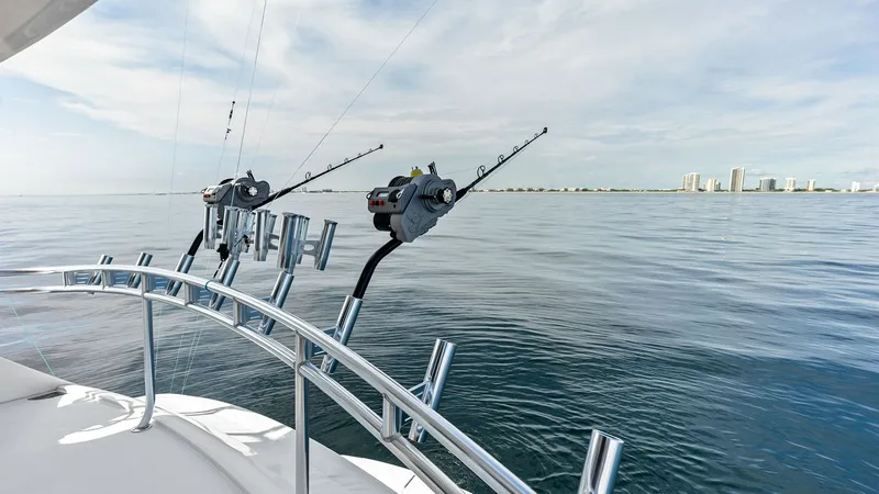 Slide: The Image of Stern Fishing Rod Holders View This image showcases the stern of the Viking 80 Convertible, highlighting its robust fishing rod holders against a serene ocean backdrop. The polished stainless steel railings add a touch of elegance and functionality, perfect for avid anglers. The expans - 7932692