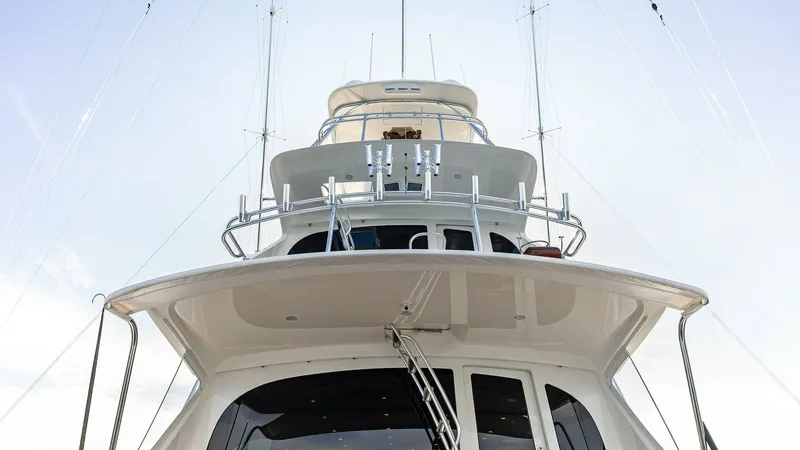 Slide: The Image of Tower and Upper Helm View This image showcases the impressive tower and upper helm of the 2017 Viking 80 Convertible, 'Aussie Rules'. The sleek design features a robust tuna tower equipped with state-of-the-art navigation equipment. The clean lines and spacious platform offer an e - 7932693