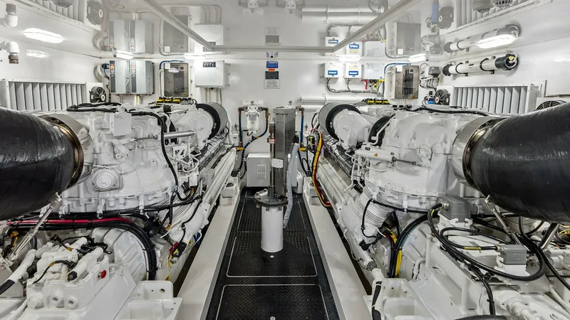 Slide: The Image of Engine Room with Twin Engines The engine room of the 2017 Viking 80 Convertible features twin powerful engines, showcasing meticulous organization and advanced engineering. The space is well-lit with ample overhead lighting, highlighting the pristine condition and high-quality materia - 7932703