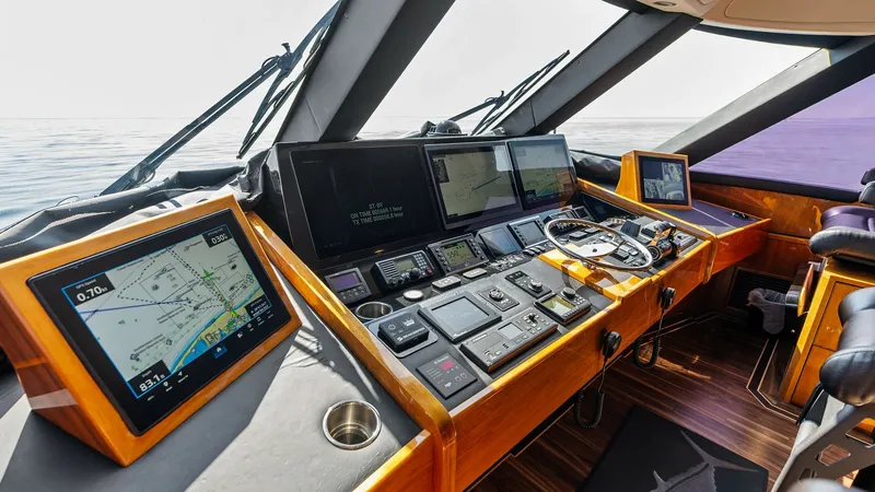Slide: The Image of Helm Station with Navigation Screens The helm station of the 2017 Viking 80 Convertible 'Aussie Rules' features state-of-the-art navigation systems and multi-function displays. The ergonomic design includes a polished wood console and leather seating, providing both style and comfort for the - 7932681