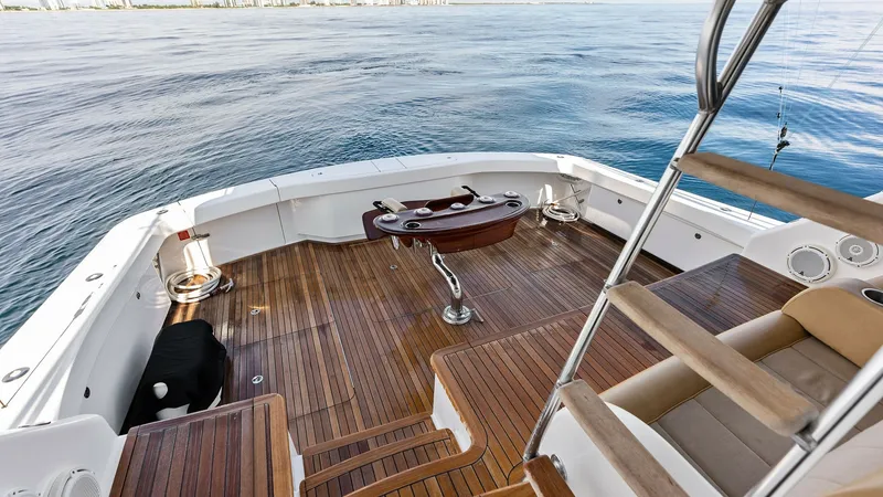 Slide: The Image of Spacious Teak Cockpit with Views This elegant cockpit on the 2017 Viking 80 Convertible features exquisite teak decking, offering both style and durability. The area is equipped with a central fighting chair, ideal for sport fishing enthusiasts. The open layout provides a seamless transi - 7932694
