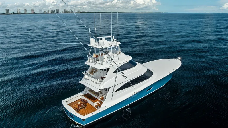 Slide: The Image of Aerial View of Viking 80 Convertible This stunning aerial shot captures the Viking 80 Convertible in all its glory, showcasing its sleek lines and robust design. The spacious aft deck is visible, equipped for fishing and leisure, with an elegant teak finish. The tower and flybridge are promi - 7932720