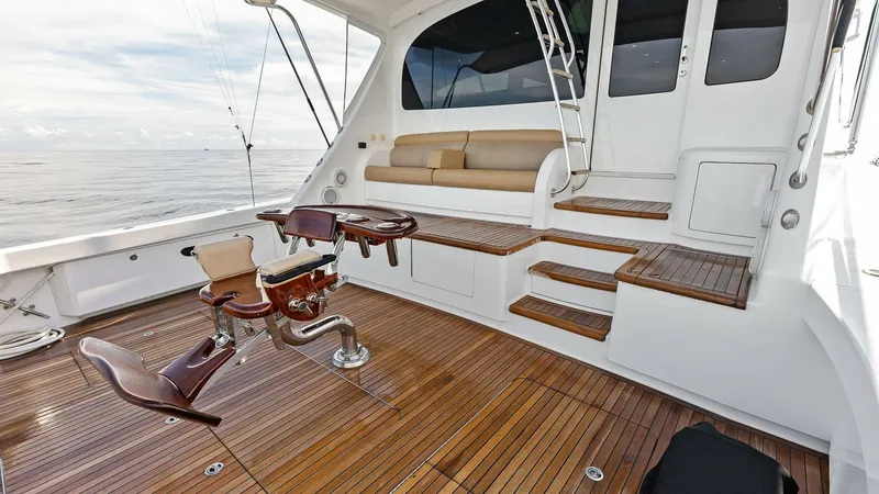 Slide: The Image of Spacious Aft Deck with Teak Flooring The Viking 80 Convertible's aft deck showcases beautifully crafted teak flooring, providing a luxurious and durable surface. Equipped with professional-grade fishing chairs, this space is perfect for avid anglers. The comfortable seating area and seamless - 7932647