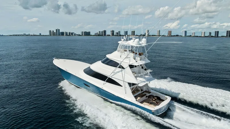 Slide: The Image of Aerial View of Viking 80 Convertible This striking aerial shot showcases the sleek design and powerful performance of the 2017 Viking 80 Convertible, 'Aussie Rules.' The vessel cuts through the water with ease, highlighting its robust hull and spacious flybridge. Its elegant lines and advanc - 7932726