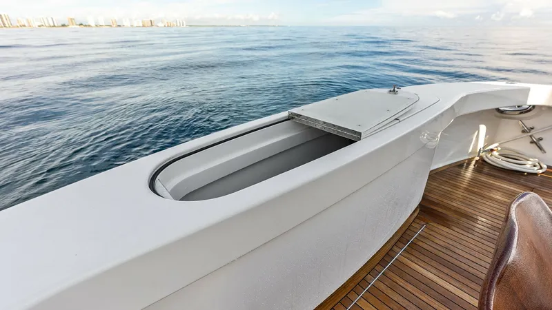 Slide: The Image of Cockpit Live Bait Well This image showcases the cockpit area with a built-in live bait well, designed for serious anglers. The clean, white finish contrasts beautifully with the teak decking, providing both style and functionality. Ideal for fishing enthusiasts, this feature en - 7932700