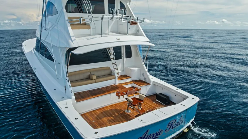 Slide: The Image of Aft Deck with Fishing Chair The aft deck of the 2017 Viking 80 Convertible 'Aussie Rules' features a spacious and well-appointed fishing area. The high-quality teak flooring complements the functional design, which includes a central fighting chair for optimal sportfishing experienc - 7932722