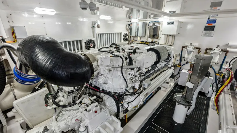 Slide: The Image of Engine Room with Twin Engines This image showcases the meticulously organized engine room of the 2017 Viking 80 Convertible, featuring powerful twin engines. The space is clean and well-lit, highlighting the advanced engineering and robust performance capabilities. The layout ensures - 7932705