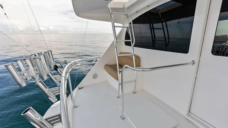 Slide: The Image of Flybridge Access with Rod Holders This image showcases the flybridge access on the Viking 80 Convertible, featuring a sleek ladder and safety railing for secure entry. The spacious layout includes a series of well-designed rod holders, ideal for fishing enthusiasts. The clean lines and qu - 7932687