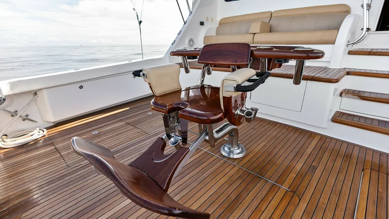 Slide: The Image of Teak Cockpit with Fighting Chair The cockpit of the 2017 Viking 80 Convertible features elegant teak decking and a professional-grade fighting chair, ideal for sport fishing enthusiasts. The elevated seating area provides a comfortable vantage point, ensuring a seamless blend of luxury a - 7932696