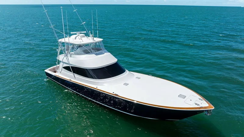 Slide: The Image of Aerial View of Sleek Bow This image captures the elegant bow of the 2024 Viking 68 Convertible, 'Laid Back', cutting through the serene waters. The streamlined design and glossy finish emphasize its modern craftsmanship. The spacious foredeck offers a clean, unobstructed view, en - 7933176