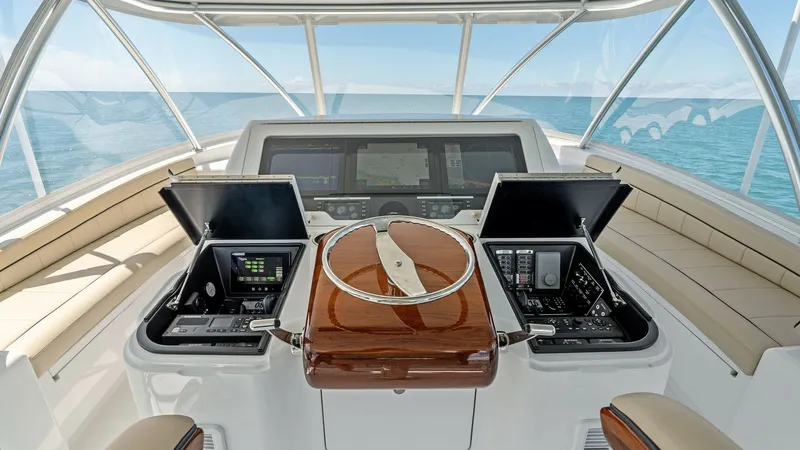 Slide: The Image of Flybridge Helm Station with Electronics The flybridge helm station of the 2024 Viking 68 Convertible offers a commanding view with state-of-the-art navigation and control systems. Twin display screens are elegantly integrated into the console, providing comprehensive access to all necessary con - 7933162