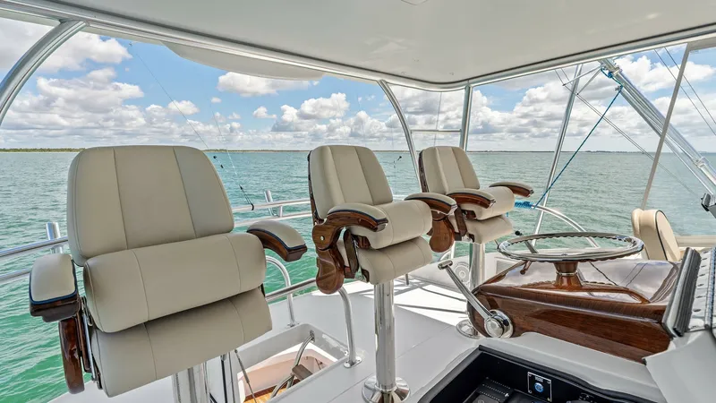 Slide: The Image of Flybridge Helm with Captain's Chairs The spacious flybridge of the 2024 Viking 68 Convertible features luxurious captain's chairs with plush upholstery, offering exceptional comfort and support. The helm is equipped with state-of-the-art navigation controls, ensuring smooth and precise handl - 7933166