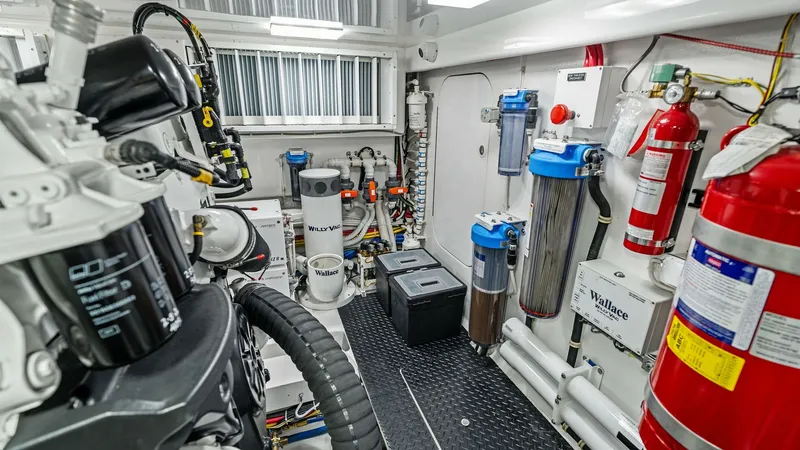 Slide: The Image of Engine Room with Advanced Systems The engine room of the 2024 Viking 68 Convertible 'Laid Back' showcases a meticulously organized layout featuring advanced mechanical and filtration systems. High-quality components and efficient design ensure optimal performance and reliability. Bright l - 7933150