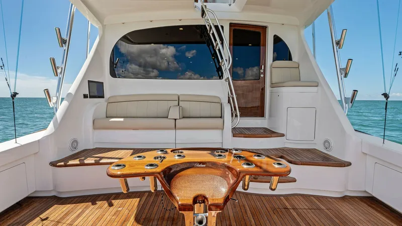 Slide: The Image of Spacious Aft Deck with Seating Area The aft deck of the 2024 Viking 68 Convertible offers a luxurious and functional space for relaxation and entertainment. Featuring a beautifully crafted wooden table and ample seating, this area is designed for comfort and style. The pristine teak floorin - 7933120