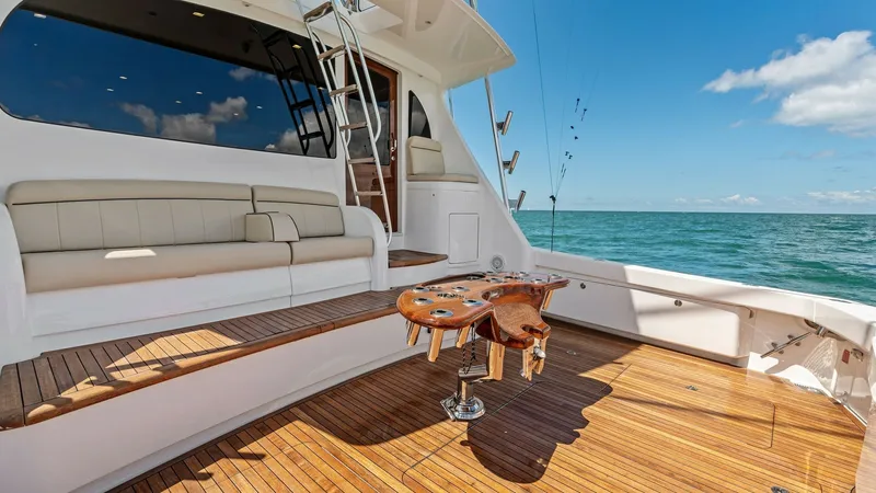 Slide: The Image of Spacious Teak Cockpit with Seating The Viking 68 Convertible features a spacious cockpit with elegant teak flooring, ideal for both relaxation and fishing. A built-in bench seat offers comfortable seating, while the central fighting chair ensures readiness for sportfishing endeavors. The o - 7933156