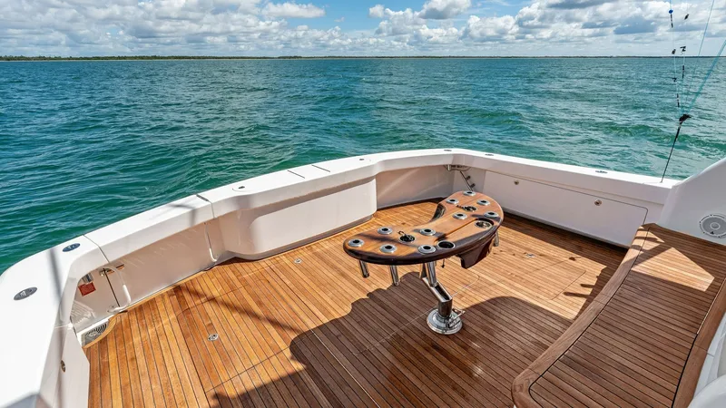 Slide: The Image of Spacious Teak Cockpit with Fighting Chair This impressive cockpit of the 2024 Viking 68 Convertible features a beautifully crafted teak deck, offering both durability and elegance. Central to the space is a professional-grade fighting chair, ideal for avid anglers seeking adventure. The expansive - 7933157