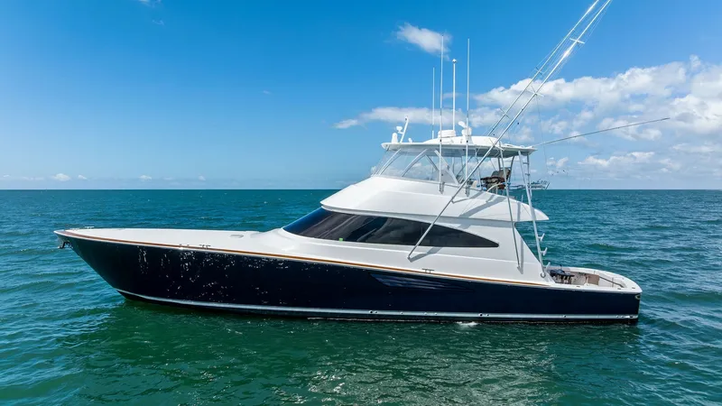 Slide: The Image of Starboard Profile of Viking 68 Convertible The 2024 Viking 68 Convertible showcases a sleek and powerful starboard profile, emphasizing its deep blue hull and elegant white superstructure. This impressive vessel is designed for both luxury and performance, featuring a spacious flybridge equipped w - 7933171