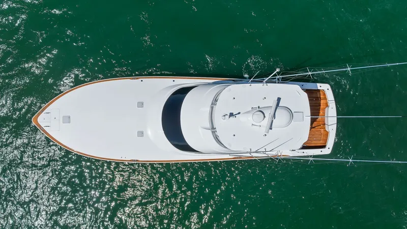 Slide: The Image of Aerial View of Flybridge and Bow This overhead shot of the 2024 Viking 68 Convertible showcases the sleek design and spacious layout of the flybridge and bow area. The clean lines and expansive deck space are complemented by the vessel's advanced engineering and craftsmanship. The teak a - 7933177