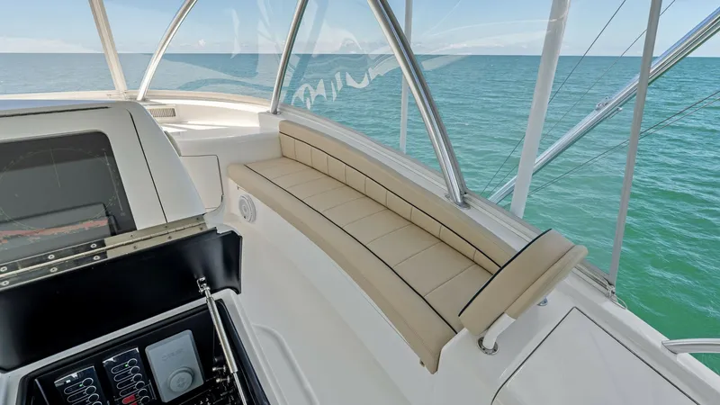 Slide: The Image of Flybridge Seating with Ocean View This image showcases the spacious flybridge seating area of the 2024 Viking 68 Convertible. The elegant, curved bench is upholstered in high-quality, weather-resistant material, offering comfort and durability. Expansive views of the ocean are visible thr - 7933163