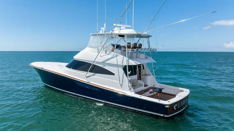 Slide: The Image of Aerial View of Aft Deck and Flybridge This image showcases the spacious aft deck and elevated flybridge of the 2024 Viking 68 Convertible. The sleek blue hull complements the elegant white superstructure, creating an eye-catching contrast. The aft deck is designed for both leisure and sport f - 7933172
