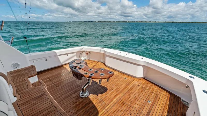 Slide: The Image of Spacious Aft Deck with Fighting Chair The aft deck of the 2024 Viking 68 Convertible showcases a beautifully crafted teak floor, offering a luxurious and durable finish. Central to this space is a professional-grade fighting chair, ideal for avid fishermen. The open layout provides ample room - 7933159