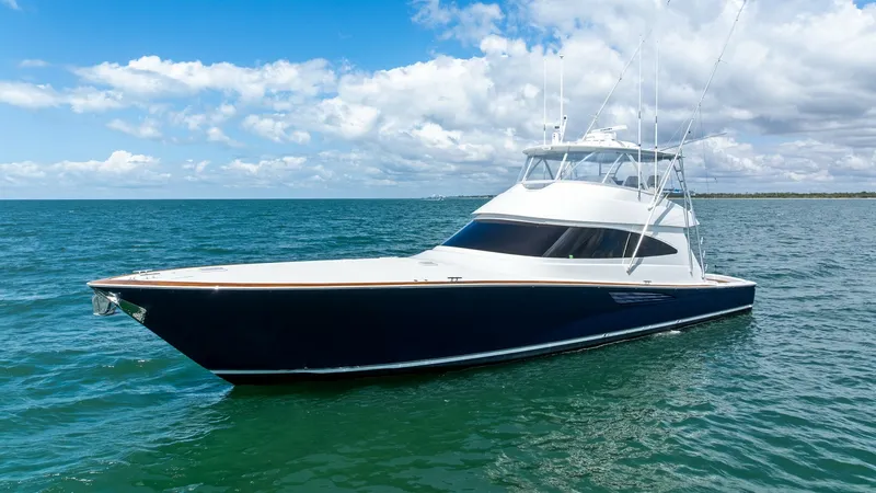 The Image of Bow View in Open Water This image showcases the sleek starboard bow of the 2024 Viking 68 Convertible, 'Laid Back', cutting through the serene open water. The vessel's elegant lines and deep blue hull highlight its powerful yet sophisticated design. The flybridge offers expansi - 7933117