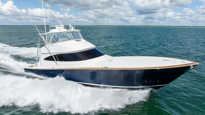 Slide: The Image of Dynamic Bow View Underway The 2024 Viking 68 Convertible, 'Laid Back', slices through the water with its sleek hull and powerful engines. The impressive bow design combines elegance with functionality, ensuring a smooth and exhilarating ride. The striking blue and white exterior i - 7933178