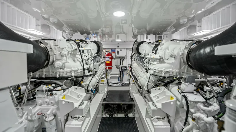 Slide: The Image of Engine Room with Twin Diesel Engines The engine room of the 2024 Viking 68 Convertible features twin powerful diesel engines, showcasing precision engineering and robust performance capabilities. The space is meticulously organized, with easy access to essential systems and controls, ensurin - 7933151
