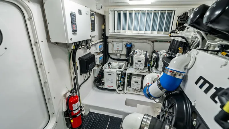 Slide: The Image of Engine Room with Advanced Systems The engine room of the 2024 Viking 68 Convertible 'Laid Back' showcases a meticulously organized layout with advanced mechanical systems. The space is equipped with state-of-the-art engines, generators, and electrical panels, emphasizing efficiency and re - 7933149