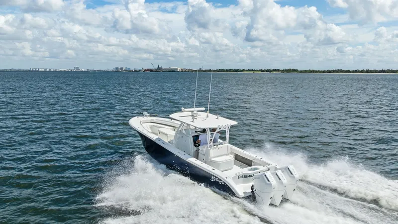 Slide: The Image of Aerial View of Center Console at Sea This 2014 Yellowfin 39 Center Console is captured cruising effortlessly across open waters. The sleek hull design and powerful twin engines ensure a smooth and efficient ride, ideal for offshore adventures. The spacious deck layout offers ample seating an - 7943359