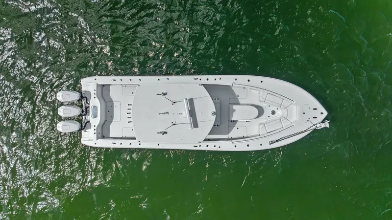 Slide: The Image of Aerial View of Center Console Layout This aerial shot showcases the sleek design of the 2014 Yellowfin 39 Center Console. The spacious deck layout is optimized for both comfort and functionality, featuring ample seating and storage options. The triple outboard engines promise impressive perf - 7943354