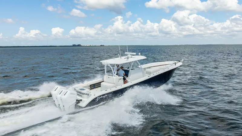 Slide: The Image of Dynamic Side View at Sea This 2014 Yellowfin 39 Center Console is captured in action, cutting through the waves with its sleek hull design. The vessel features a spacious helm area protected by a sturdy T-top, providing both function and style. Its powerful outboard engines ensur - 7943357
