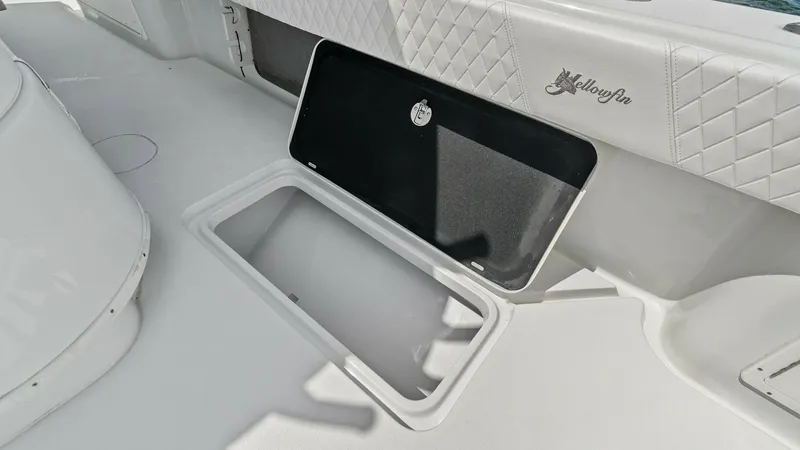 Slide: The Image of Cockpit Storage Compartment This image showcases the spacious storage compartment located in the cockpit of the 2014 Yellowfin 39 Center Console. The hatch opens to reveal a clean, well-finished interior, ideal for stowing gear securely. The surrounding area features high-quality, d - 7943306