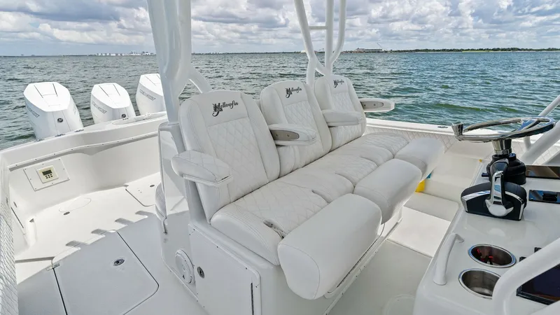 Slide: The Image of Helm Seating Area with Console The image showcases the helm seating area of the 2014 Yellowfin 39 Center Console, featuring plush, diamond-stitched upholstery for maximum comfort. The helm includes a sophisticated steering console with cup holders and easy access to controls, enhancing - 7943320