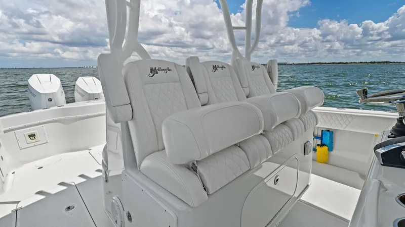 Slide: The Image of Helm Seating with Ocean View This image showcases the helm seating area of the 2014 Yellowfin 39 Center Console. The white, diamond-stitched upholstery offers comfort and style against the stunning backdrop of the open ocean. The seating design is both ergonomic and luxurious, provid - 7943316