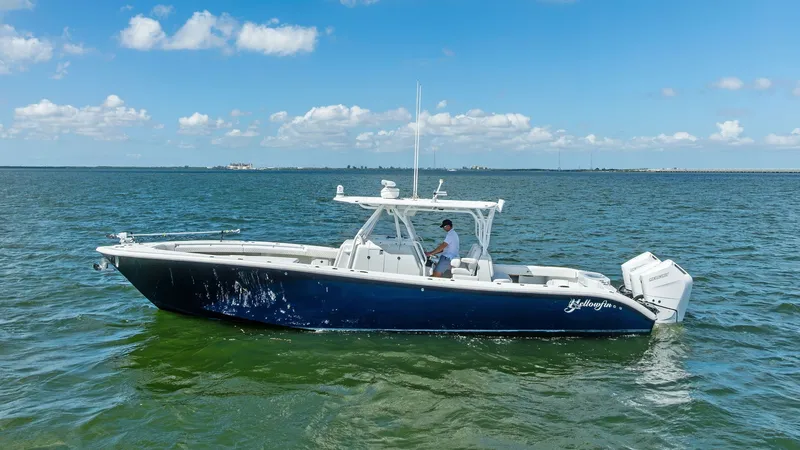 Slide: The Image of Side Profile of 39 Center Console This 2014 Yellowfin 39 Center Console features a sleek navy hull that cuts effortlessly through the water. The spacious deck layout is designed for both comfort and functionality, perfect for fishing trips or leisure cruising. The dual outboard engines pr - 7943346